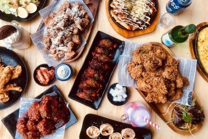 A spread of Korean fried chicken and side dishes at Simya